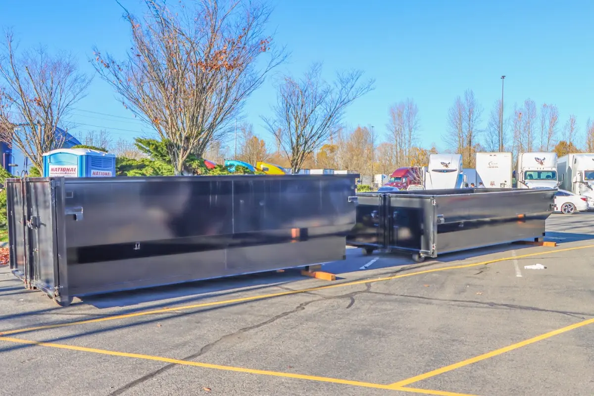 Professional dumpster rental service with roll-off container on residential driveway in Hellam